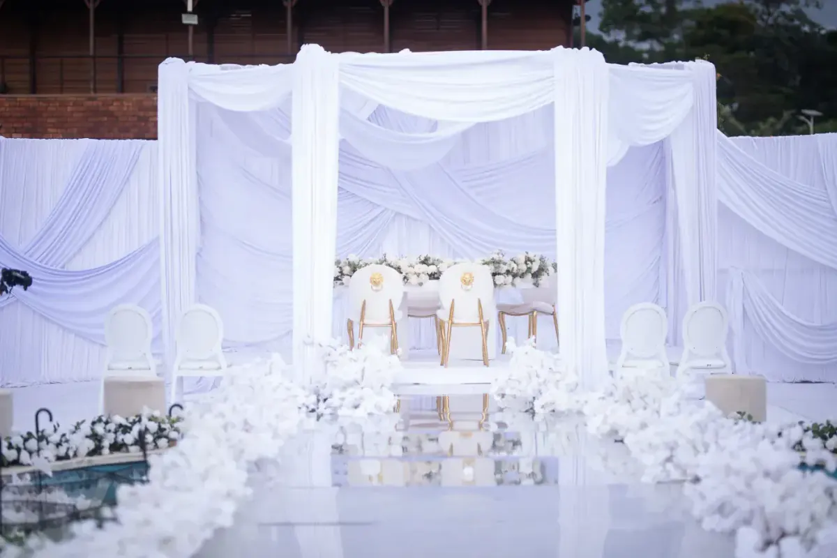 Reception hall decorated in white, ready for a wedding