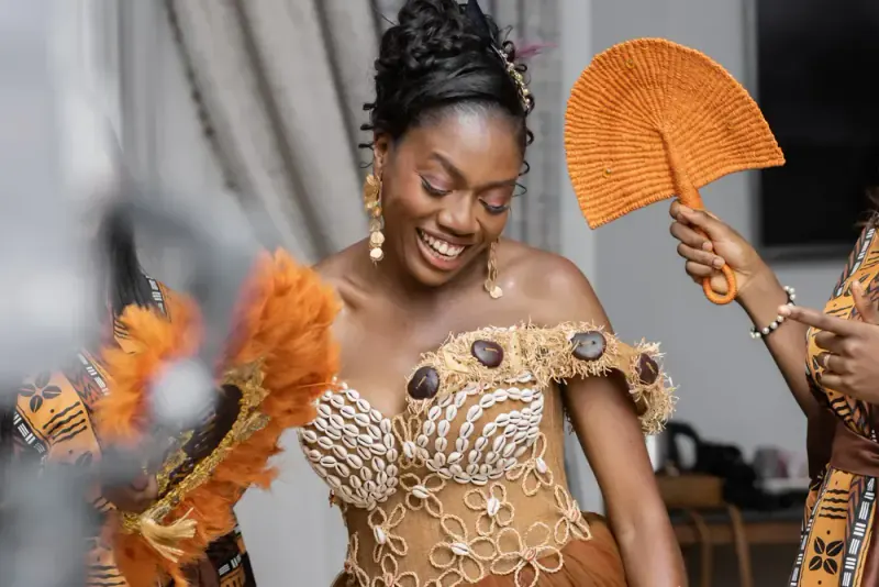 Bride in traditional dress dancing, surrounded by her loved ones